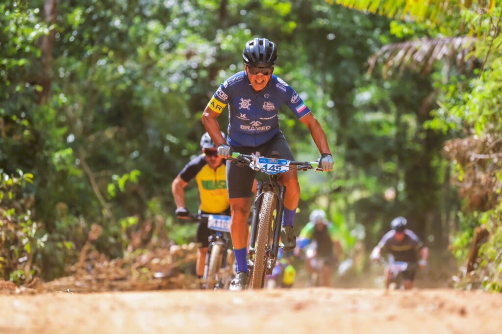 Cyclists pedaling on dirt path